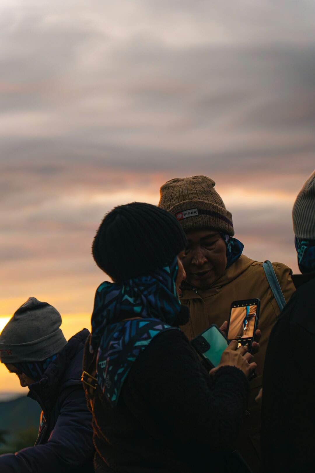 Community members reviewing documentary photographs outdoors